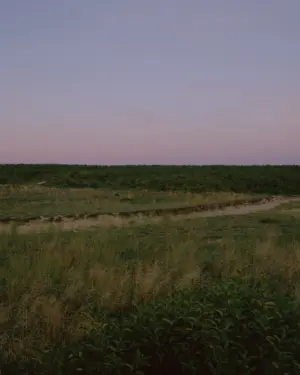 This eight-panel panoramic landscape photograph shows the rising moon on the left and the setting sun on the right from a vantage point overlooking Cape Cod Bay.