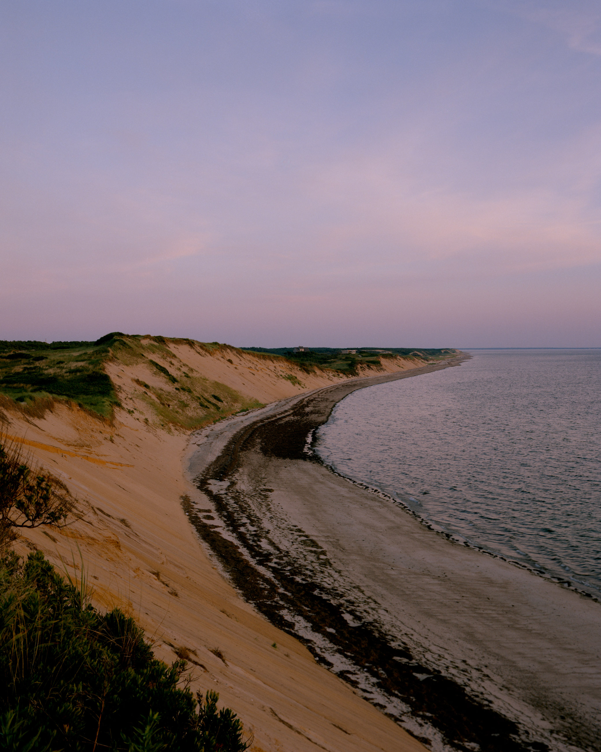 This eight-panel panoramic landscape photograph shows the rising moon on the left and the setting sun on the right from a vantage point overlooking Cape Cod Bay.