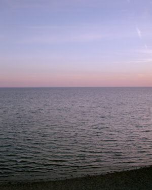 This eight-panel panoramic landscape photograph shows the rising moon on the left and the setting sun on the right from a vantage point overlooking Cape Cod Bay.