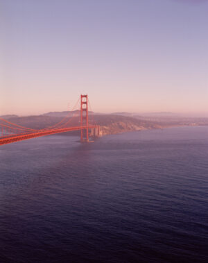 This six-panel panoramic photograph shows the Golden Gate Bridge spanning from the Marin Headlands over to San Francisco.