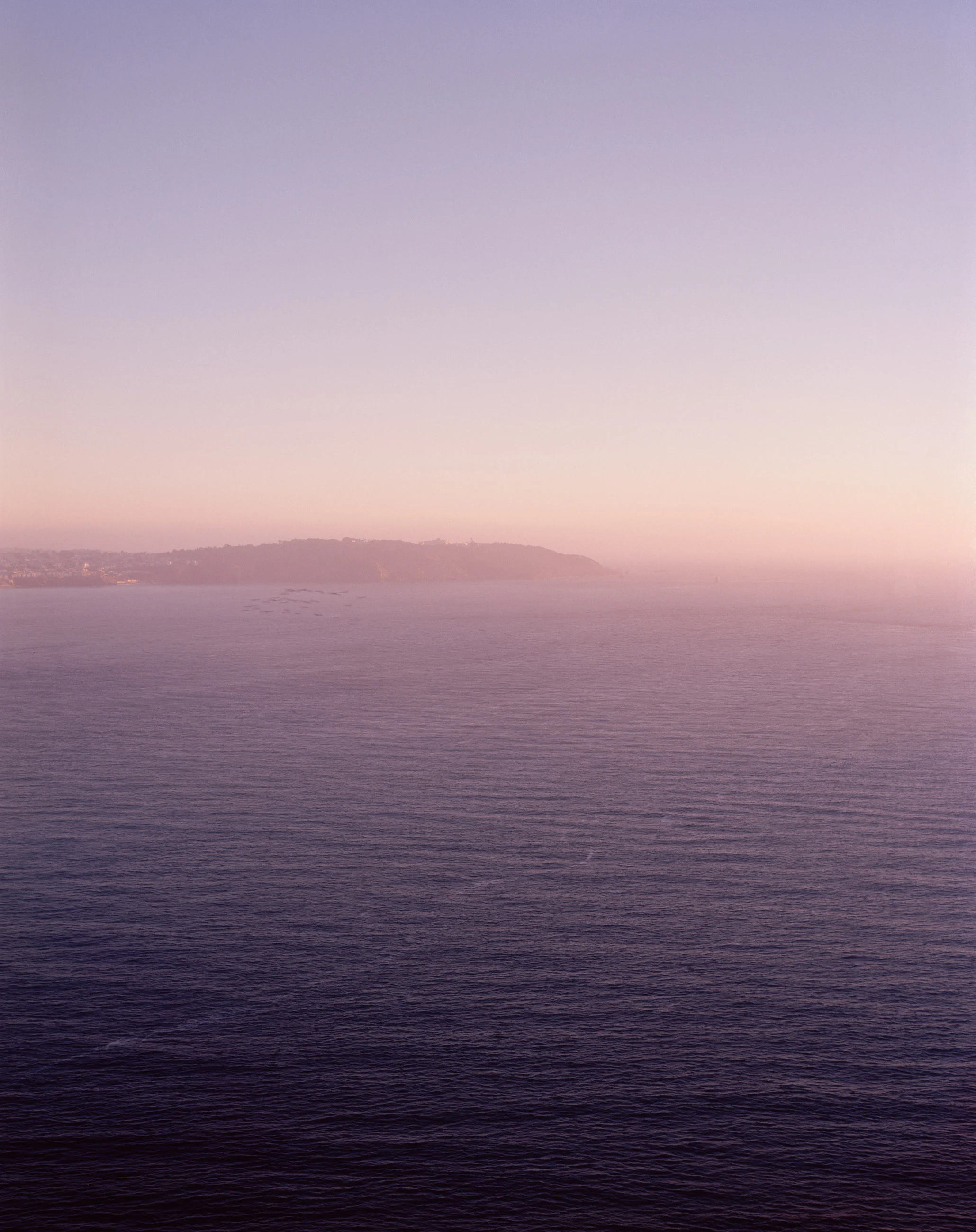 This six-panel panoramic photograph shows the Golden Gate Bridge spanning from the Marin Headlands over to San Francisco.
